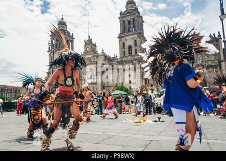 Mexico City, Mexico : Aztec people dancing opposite the Cathedral at the Zócalo square (Plaza de la Constitución) in the historic center of  Mexico Ci Stock Photo