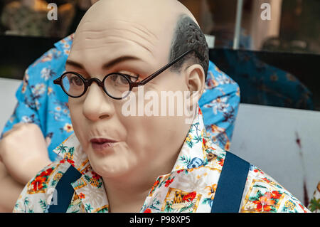 lifelike male doll head with round glasses on the nose Stock Photo