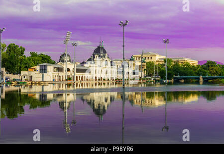 The building of a city ice rink in Budapest against the backdrop of a lake.Pink and violet toning. Stock Photo