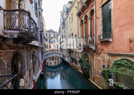 Venice canal with ancient buildings and houses facades in Italy Stock Photo