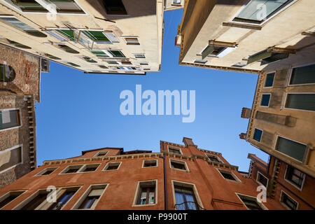 Venice buildings and houses facades low angle view in a sunny day, blue sky in Italy Stock Photo