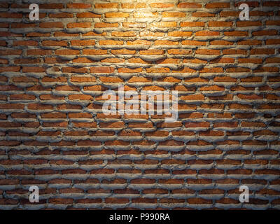 Brick wall background texture unique design. Cement overfall from joint of brick wall and the light from above. Stock Photo