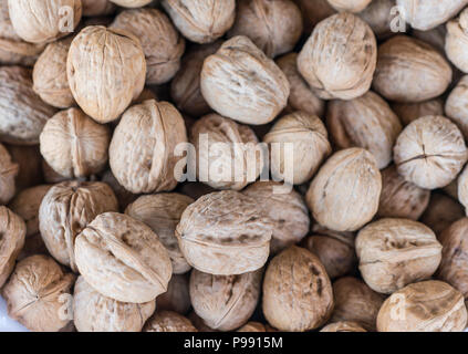 Walnuts in shells on a market Stock Photo