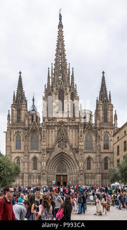 People thronging round the main portal of Barcelona Cathedral, or The Cathedral of the Holy Cross and Saint Eulalia in Stock Photo