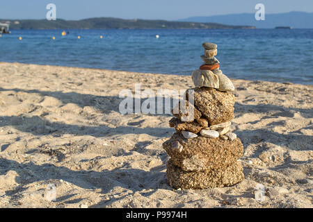 Stones balance on beach shot at sunset. Stock Photo
