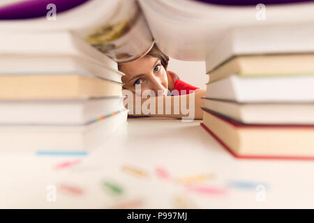 people, education, session, exams and school concept - tired student with books Stock Photo