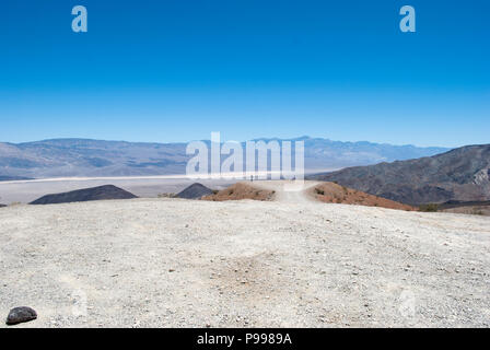 Woman walking away. Man walking away. Open panoramic view on mountains and valley Stock Photo