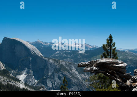 Mountain range on horizon with blue sky. View on valley from the top of mountain. Mountains landscape of California. Yosemite trail. Stock Photo