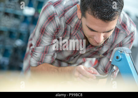 tennis stringer hands doing racket stringing in his workshop Stock Photo