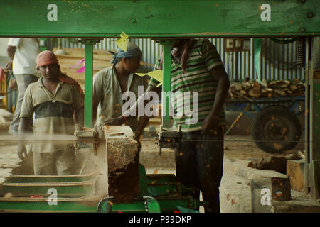 Carpenters working on an electric buzz saw cutting some boards, daily job Stock Photo