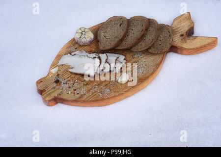 smoked lard with spice and different bread  on the board Stock Photo