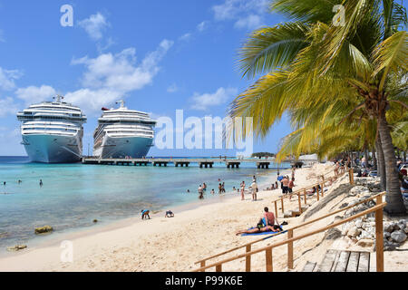 Grand Turk, Turks and Caicos Islands - April 03 2014: Carnival Cruise Ships in Grand Turk while passengers spend the sunny day at Cruise Center Beach. Stock Photo