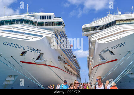 Grand Turk, Turks and Caicos Islands - April 03 2014: Carnival Liberty and Carnival Victory moored side by side at the Cruise Terminal in Grand Turk. Stock Photo