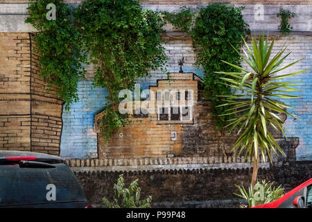 Glimpse of a street graffiti mural depicting Castle of the Holy Angel painted on a brick wall in an alley of Rome, Italy, Europe. Street art, close up Stock Photo