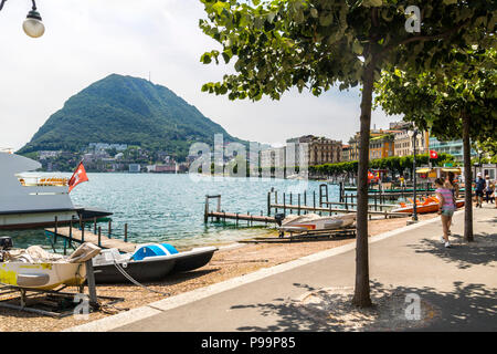 Boats moored at Lago di Lugano, monte san salvatore , Lake Lugano, Switzerland promenade lugano, tourists exploring, relaxed concept, summer holiday Stock Photo