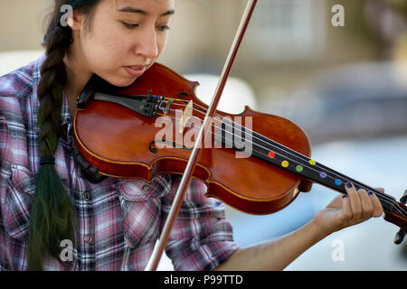 Prescott, Arizona, USA - June 30, 2018: Young woman playing a violin on the street corner of downtown Prescott Stock Photo