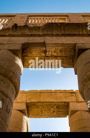 Looking up at colourful painted  Egyptian hieroglyphs at top of columns, great hypostyle hall precinct of Amun Ra, Karnak Temple. Luxor, Egypt, Africa