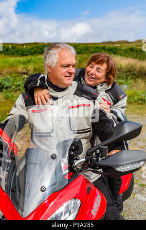 Older couple riding powerful motorbike, Ducati Multistrada 1200 Stock Photo