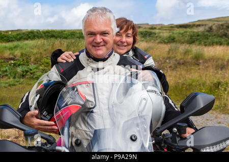 Older couple riding powerful motorbike, Ducati Multistrada 1200 Stock Photo