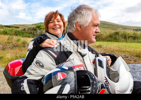 Older couple riding powerful motorbike, Ducati Multistrada 1200 Stock Photo