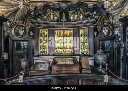 A golden cabinet at bottom to the old Pharmacy and Apothecary 'Farmacia di S. Maria della Scala' in Piazza della Scala in Trastevere quarter, Rome, Italy Stock Photo