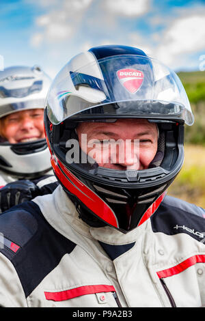 Older couple riding powerful motorbike, Ducati Multistrada 1200 Stock Photo