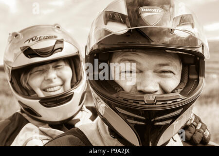 Older couple riding powerful motorbike, Ducati Multistrada 1200 Stock Photo