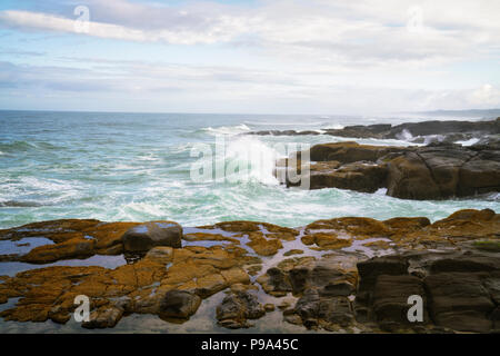 Evening approaches and sea birds take flight over Oregon’s central coastline at Yachats. Stock Photo