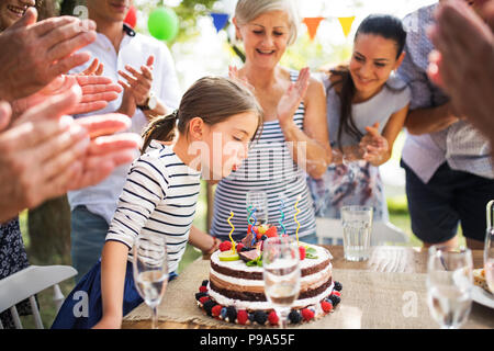 Family celebration or a garden party outside in the backyard. Stock Photo