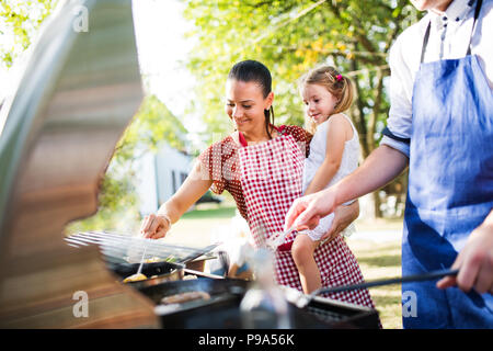 Family celebration or a barbecue party outside in the backyard. Stock Photo