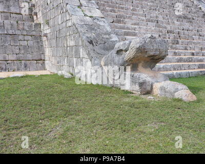 Feathered serpent sculpture at base of stairways of Kukulkan pyramid at Chichen Itza mayan town at impressive archaeological sites in Mexico in 2018 w Stock Photo
