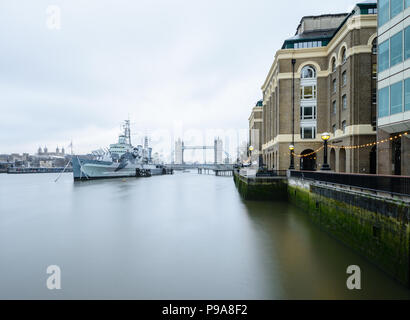 Long exposure view from by the River Thames at Queens Walk, London, of HMS Belfast, Hays Galleria, Tower Bridge and the Tower of London Stock Photo