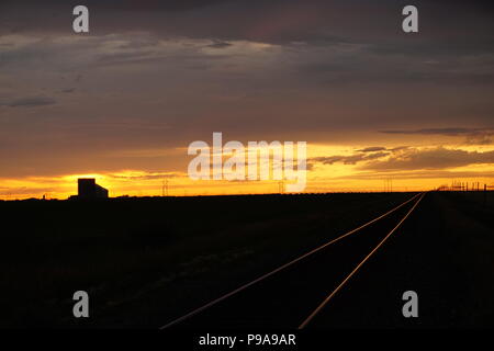 Prairie Winter, Dusk on the field of snow , leaning fence Stock Photo