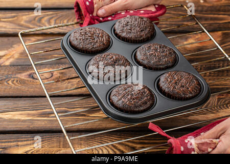Basic homemade brownie or chocolate muffins raw dough in baking pan. Cooking homemade chocolate muffins, cupcakes Stock Photo