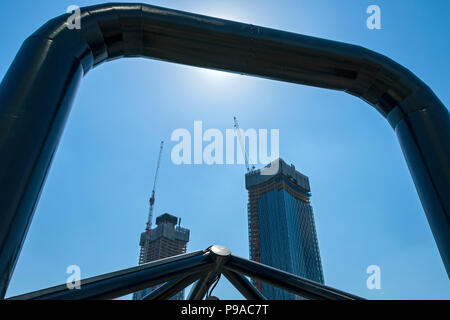 Two of the Deansgate Square apartment blocks (under construction), from the footbridge leading to Deansgate rail station, Manchester, England, UK Stock Photo