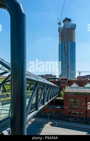 One of the Deansgate Square apartment blocks (under construction), from the footbridge leading to Deansgate rail station, Manchester, England, UK Stock Photo