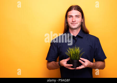 Smiling adult man proud of young plant Stock Photo