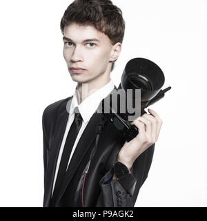 Portrait of young handsome photographer holding the camera Stock Photo