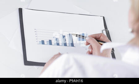 closeup.business woman analyzing marketing graphics. Stock Photo