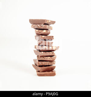 high stack of slices of original milk chocolate .isolated on white Stock Photo