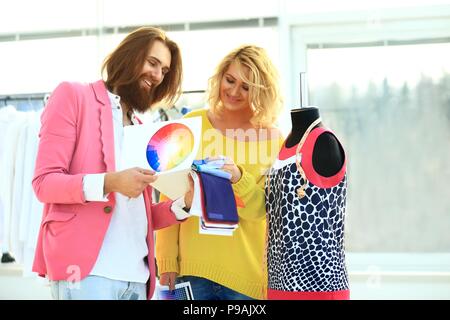 Two fashion designers discuss the color of the new clothing collection Stock Photo