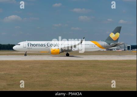A Thomas Cook Airbus A321-211 sits on the runway at Manchester Airport as it prepares to take-off. Stock Photo