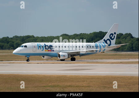 A Flybe Embraer ERJ-175STD sits on the runway at Manchester Airport as it prepares to take-off. Stock Photo