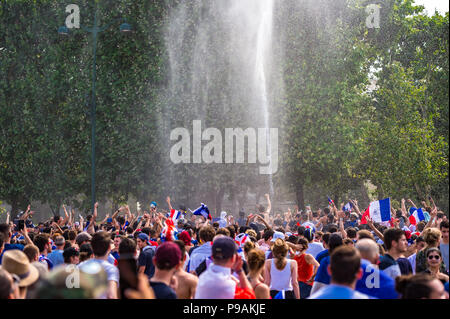 Firemen hose the crowd with water on the Champ de Mars in Paris as France wins the World Cup. Paris, France. Stock Photo