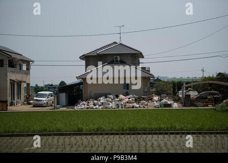 Okayama, Japan. 17th July 2018. A home with flood damage in Mabicho, Kurashiki, Okayama Prefecture, Japan. More than 200 people died in floods and landslides caused by torrential rains more than a week ago. On Sunday, the government announced the weather event would be designated an extremely severe disaster, freeing up recovery funds for the affected areas. Cleanup and recovery efforts have been hampered by extreme heat. Credit: Aflo Co. Ltd./Alamy Live News Stock Photo