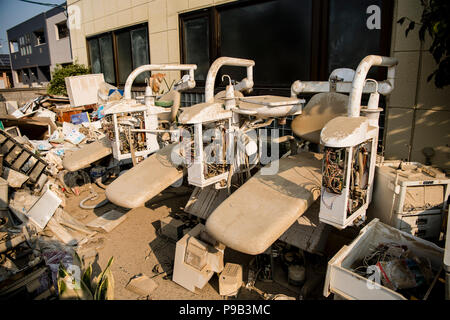 Okayama, Japan. 17th July 2018. Dentists chairs damaged by floods in Mabicho, Kurashiki, Okayama Prefecture, Japan. More than 200 people died in floods and landslides caused by torrential rains more than a week ago. On Sunday, the government announced the weather event would be designated an extremely severe disaster, freeing up recovery funds for the affected areas. Cleanup and recovery efforts have been hampered by extreme heat. Credit: Aflo Co. Ltd./Alamy Live News Stock Photo
