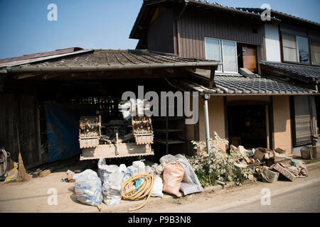 Okayama, Japan. 17th July 2018. Damaged farming equipment at a home in Mabicho, Kurashiki, Okayama Prefecture, Japan. More than 200 people died in floods and landslides caused by torrential rains more than a week ago. On Sunday, the government announced the weather event would be designated an extremely severe disaster, freeing up recovery funds for the affected areas. Cleanup and recovery efforts have been hampered by extreme heat. Credit: Aflo Co. Ltd./Alamy Live News Stock Photo