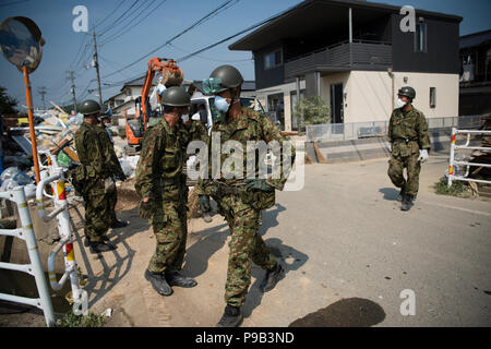 Okayama, Japan. 17th July 2018. Soldiers clean up flood damage in Mabicho, Kurashiki, Okayama Prefecture, Japan. More than 200 people died in floods and landslides caused by torrential rains more than a week ago. On Sunday, the government announced the weather event would be designated an extremely severe disaster, freeing up recovery funds for the affected areas. Cleanup and recovery efforts have been hampered by extreme heat. Credit: Aflo Co. Ltd./Alamy Live News Stock Photo
