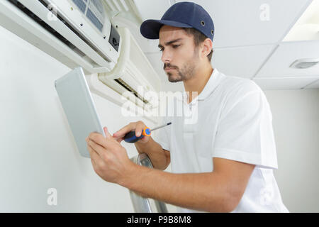 young contractor working carefully and seriously at clients office Stock Photo