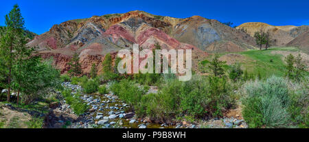 Panorama of unrealy beautiful colorful clay cliffs in Altai mountains, Russia. Summer landscape, which is called Martian and creek running between sto Stock Photo